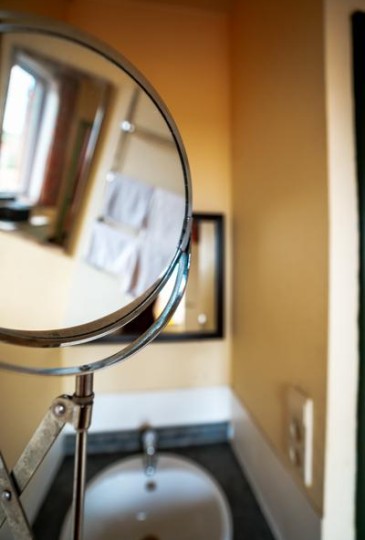Vintage shot of mirrors in bathroom of 2p family room