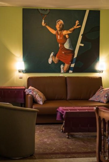 Living room of 2p family room with painting of tennis player Justine Henin